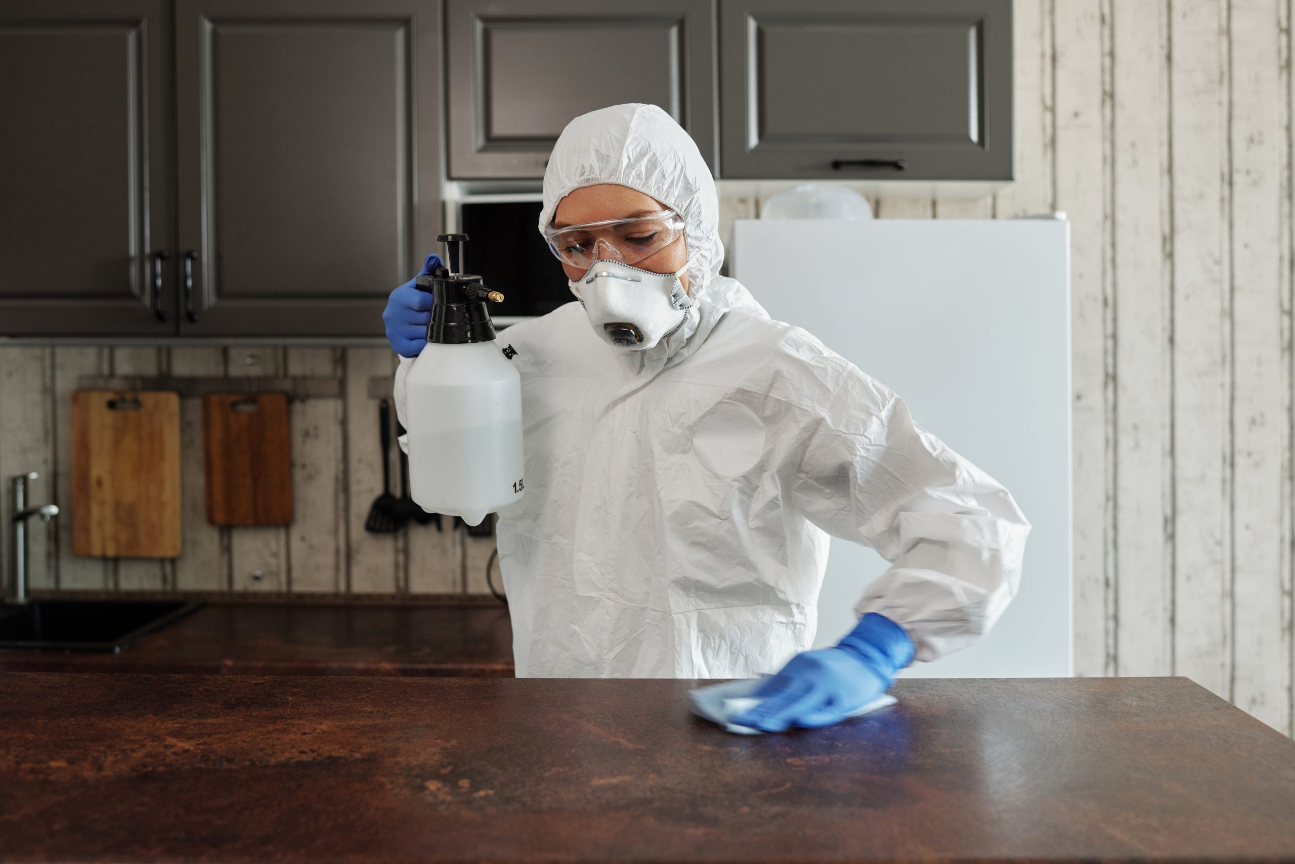 Photo of person disinfecting the table